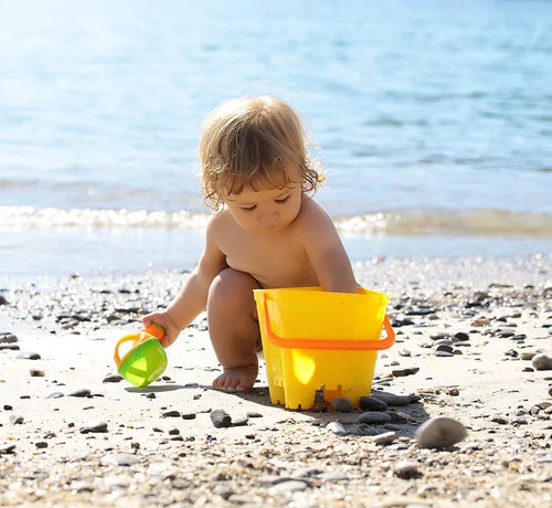 toddler doing sand castle at the beach - Mustela Australia - 1