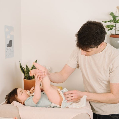 Dad changing toddler nappy - Mustela Australia - 1