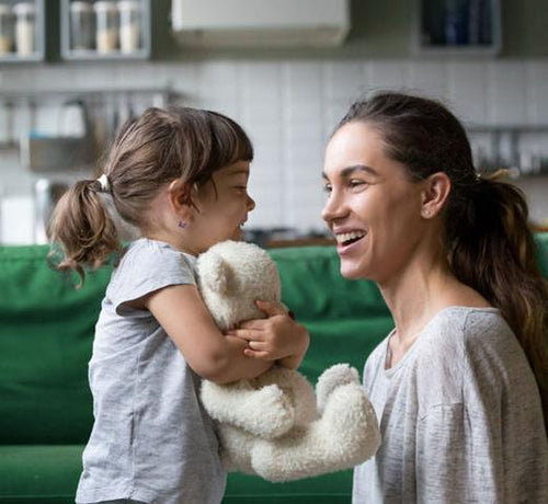 girl-holding-teddy-bear-smiling-at-a-woman - Mustela Australia - 1