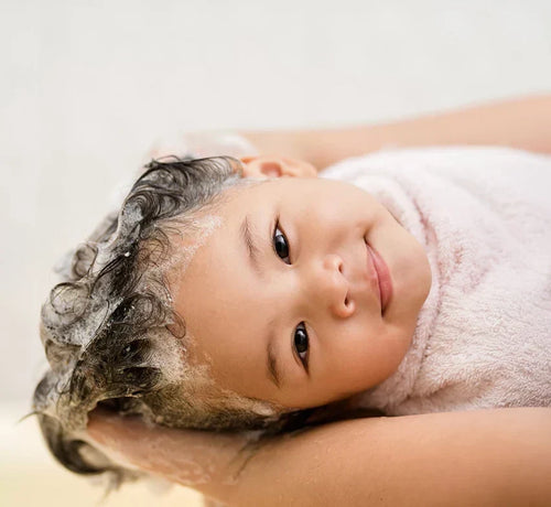 A close-up of a toddler having their hair washed. - Mustela Australia - 1